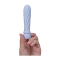 purple Symba bullet held in finger tips to show size