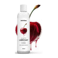 cheeky cherry lubricant bottle in front of cherry graphic