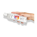 woman's hand holding euphoric orgasm lubricant on it's side