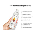woman's hand holding mango passion lubricant bottle with a list of features